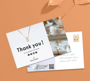 front of and back of postcards on table